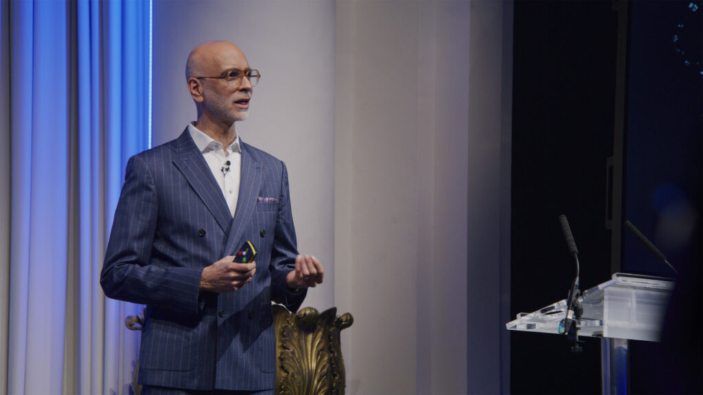 Male Conference Speaker Male speaker presenting on stage at a professional conference