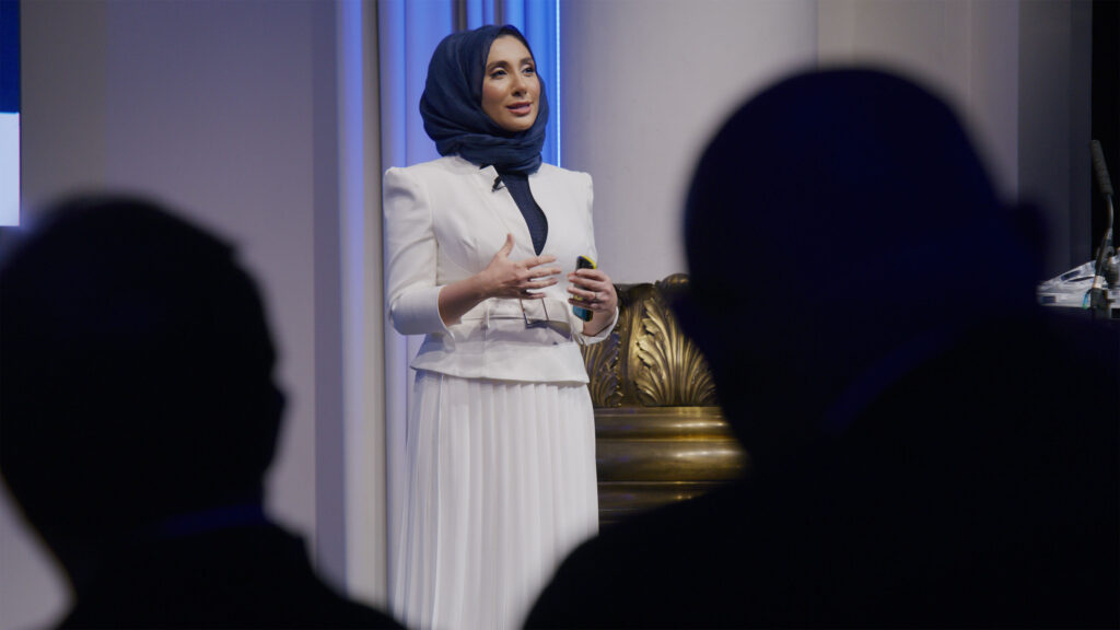Female Speaker at Event Woman in hijab speaking confidently at an elegant venue event