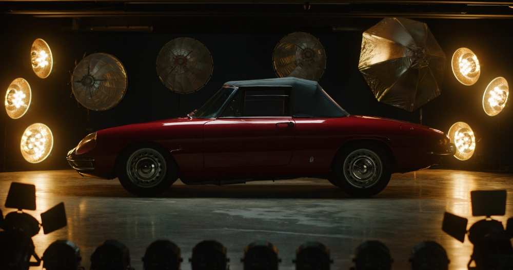 Classic Convertible Reveal Red classic convertible sports car on lit studio stage