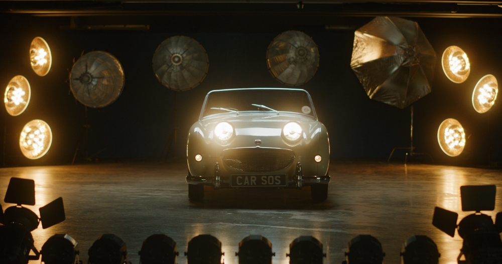 Classic Mini Stage Reveal Classic Mini Cooper on stage surrounded by studio spotlights