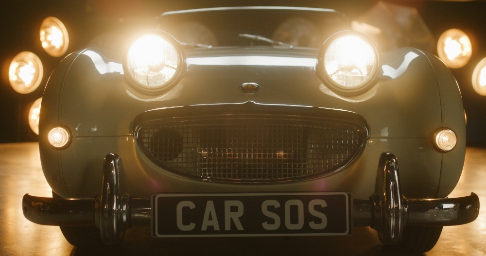 Car SOS classic car front grille with number plate in studio
