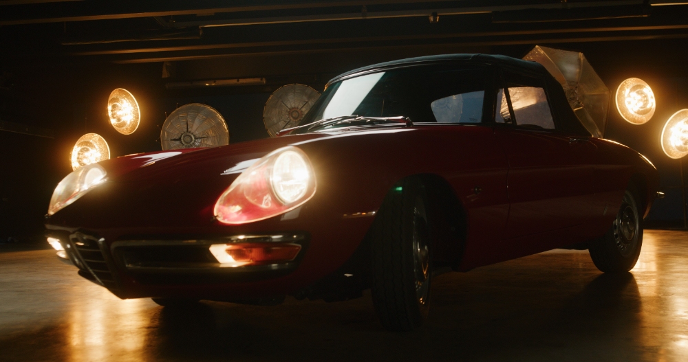 Classic Red Sports Car Classic red sports car with headlights on in moody garage