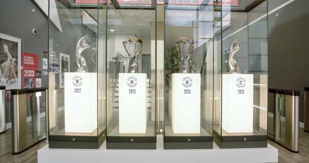 Sports trophies displayed in glass cases at a stadium venue