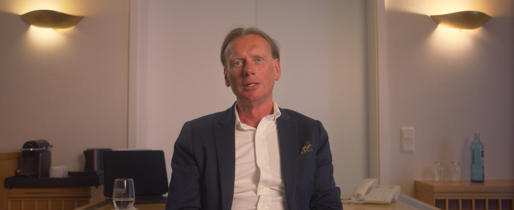 Man in blue blazer in Kedrion Factor X German case study film
