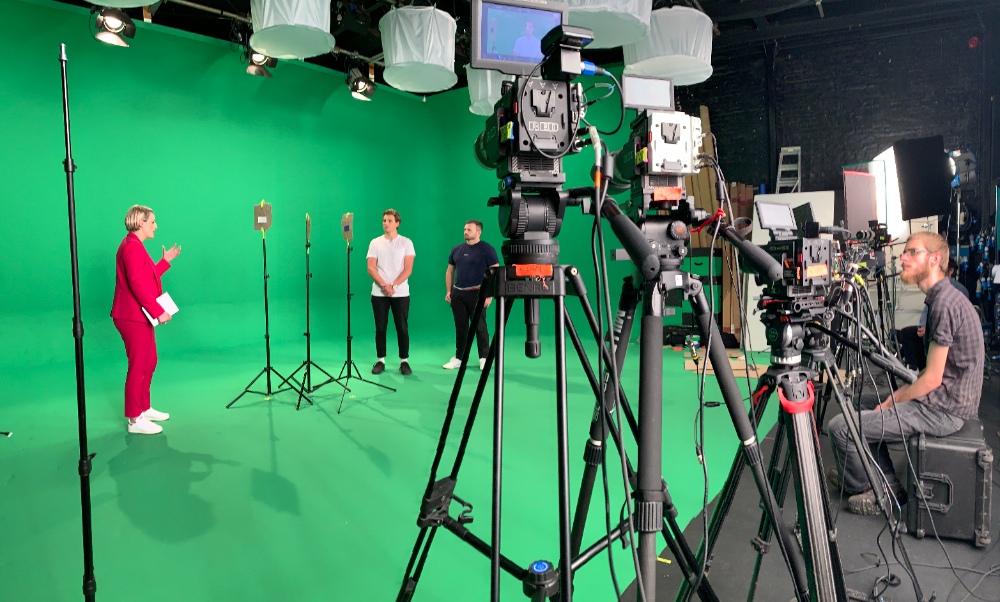 Green Screen Production Film crew shooting on green screen stage with multiple cameras