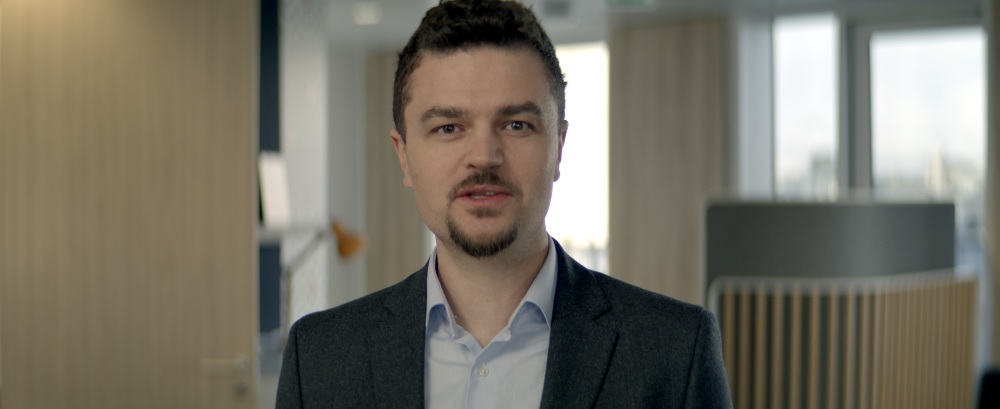 TEUR On-Camera Interview Young man in a blazer speaking to camera in an office