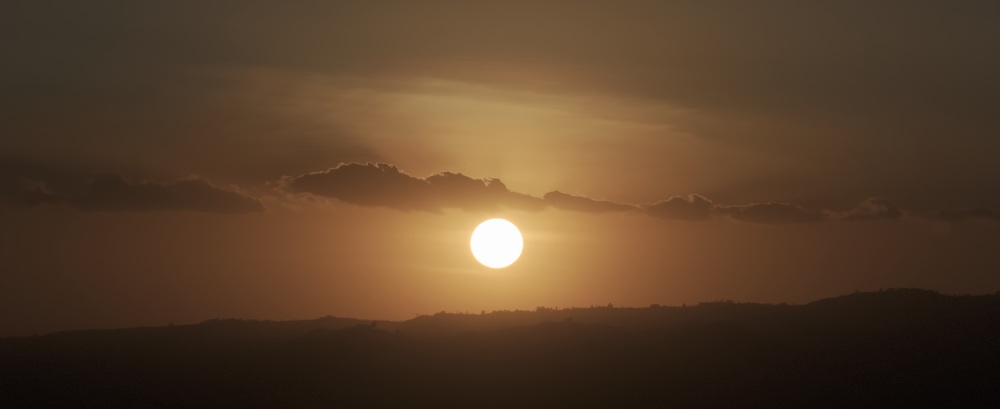 Dramatic Desert Sunset Golden sunset over a dark mountain silhouette
