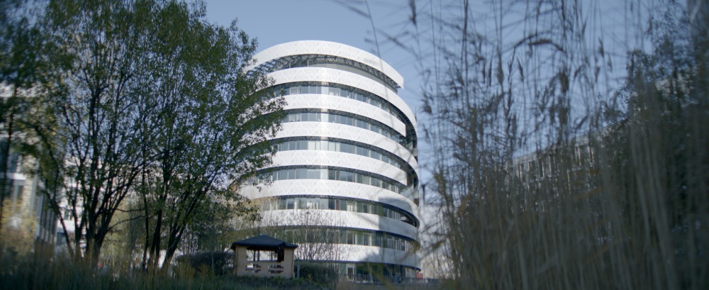 TEUR Corporate Headquarters Modern circular office building surrounded by trees