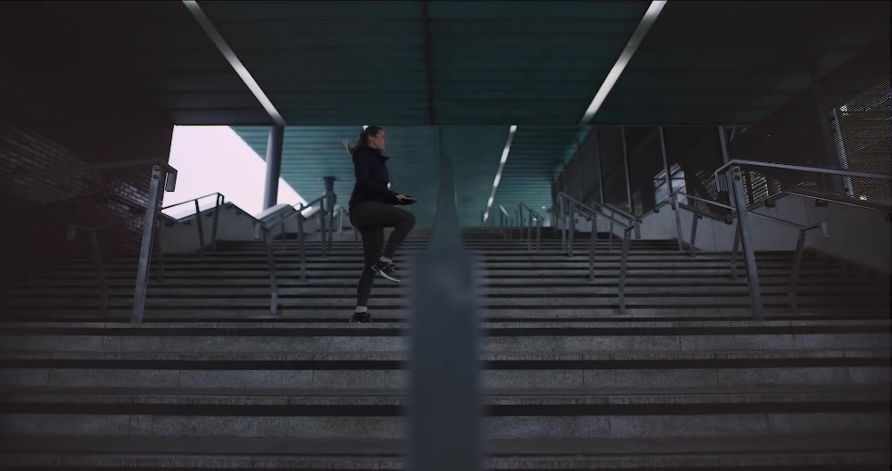 Urban Staircase Run Athlete running up concrete staircase under urban overpass