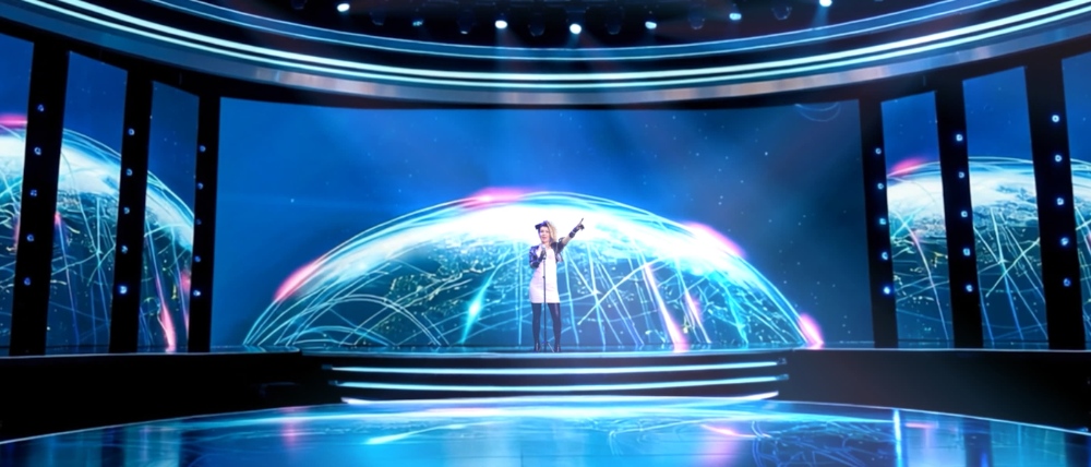 Singer performing on large LED dome concert stage