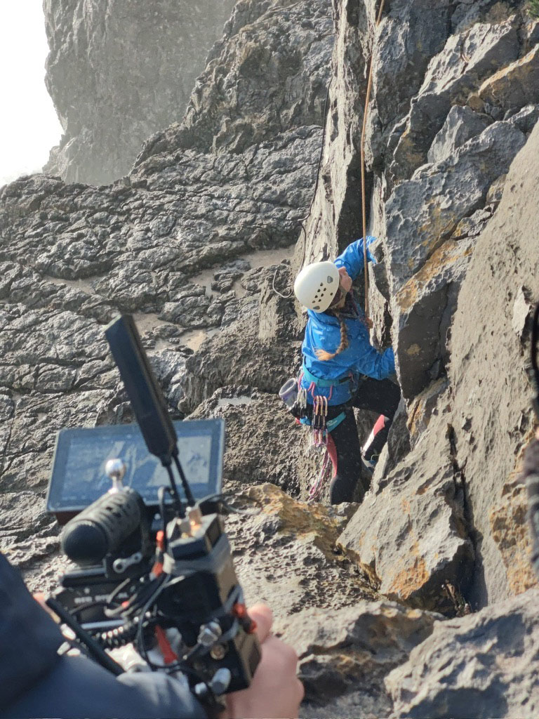 Rock Climber Film Shoot Camera crew filming a rock climber scaling a cliff face
