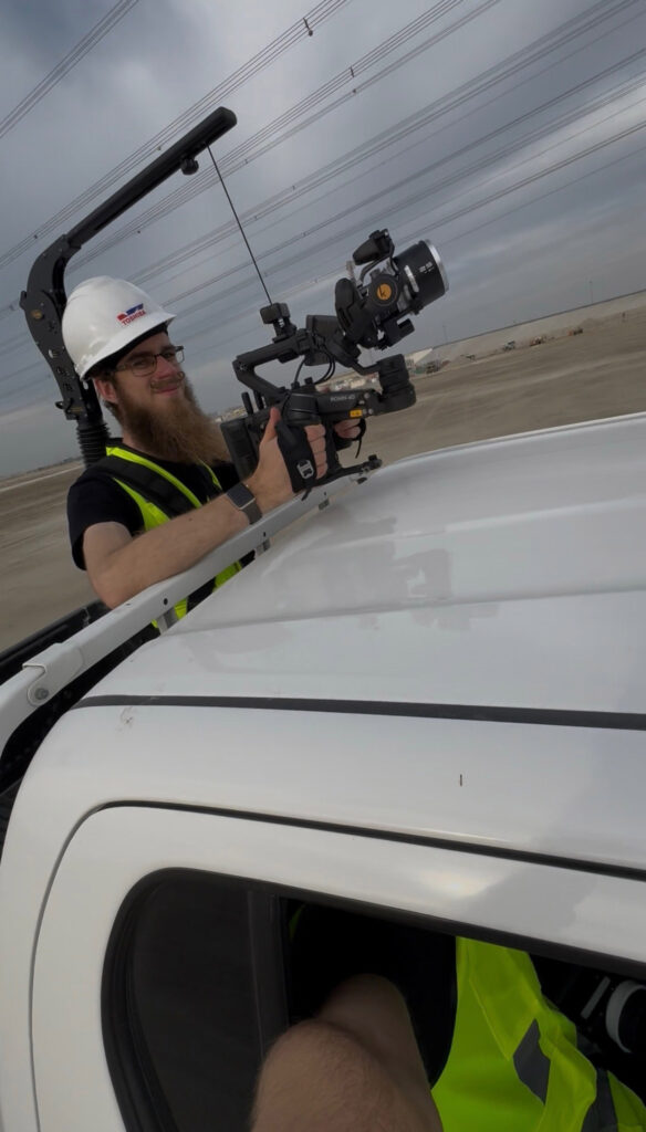 Van Camera Shoot Man leaning out of a van recording with a camera gimbal