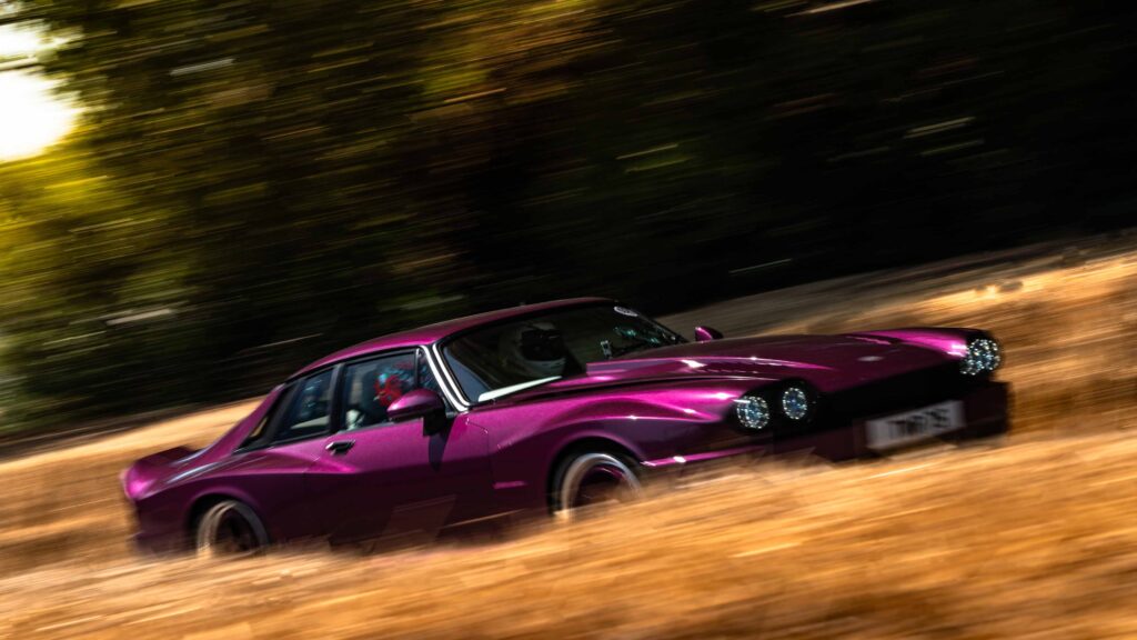 Purple Saloon Hillclimb Purple classic saloon car speeding through hillclimb course